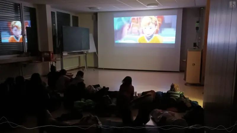 Schler schauen einen Film auf groer Leinwand